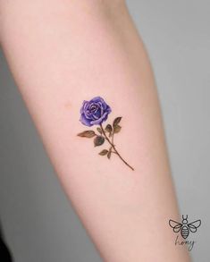 a purple rose tattoo on the arm