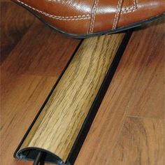 a pair of brown shoes sitting on top of a wooden floor