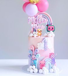 a birthday cake with balloons and animals on the top is decorated in pastel colors