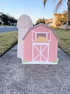 a paper cut out of a pink barn