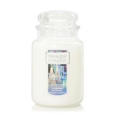 the yankee candle is white and has a glass lid