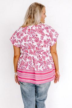 - Show your feminine side in this beautiful babydoll top! - Unlined, lightweight material with a fuchsia hued paisley pattern - A v-cut neckline with gathered detail at the back and shoulders - Short, loose sleeves - Button accents on the front - A relaxed silhouette that ends in a straight hemline Pink Flowy Short Sleeve Top, Flowy Pink Printed Tops, Pink V-neck Top With Paisley Print, Pink Paisley Print V-neck Top, Bohemian Pink Paisley Print Tops, Casual Pink Paisley Print Tops, Loose Sleeves, Relaxed Jeans, Babydoll Top