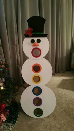 a snowman made out of toilet paper and colored circles