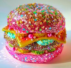 there is a large hamburger made out of glitters and sprinkles on it