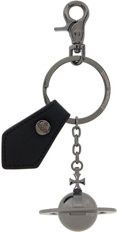 a metal object with a black key chain hanging from it's center ring and a leather tag attached to it