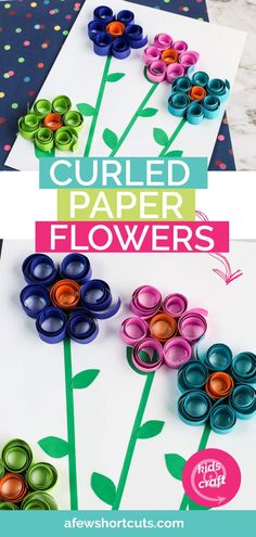 some paper flowers are on the table and one is made out of rolled up papers