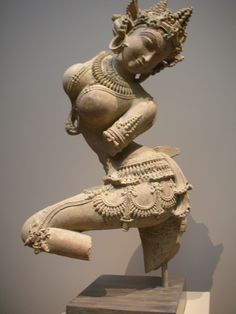 an ancient statue is displayed in a museum