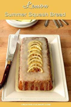 there is a cake with slices of lemons on it and a knife next to it