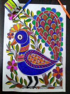 a colorful bird is sitting on top of a piece of paper next to a paintbrush