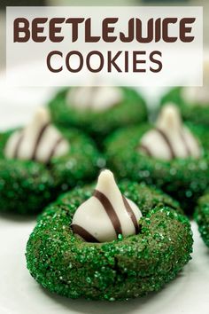 some green cookies with white and brown candy on top are arranged in the shape of wreaths