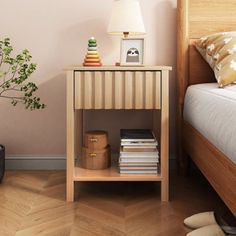 a bedroom with a bed, nightstand and small plant on the side table next to it