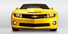 the front end of a yellow chevrolet camaro on a white background with no people around it