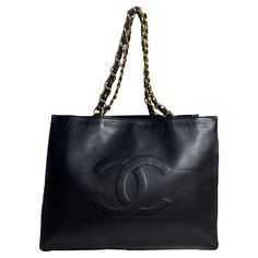 Chanel Vintage Black Leather CC Logo Tote Bag.  Features leather laced chain straps.  Made In: France Year of Production: 1994-1996 Color: Black Hardware: Goldtone Materials: Smooth lambskin leather Lining: Leather Closure/Opening: Open top  Interior Pockets: One zip Exterior Condition: Very good condition with some wear throughout Interior Condition: Very good  Measurements: 16"W 12"H x 4"D Handle Drop: 4" Strap Drop: 11" Tote Chanel, Dior New Look, Wool Tote, Vintage Chanel Bag, Logo Tote Bag, Chanel Suit, Chanel Brand, Chanel Tote, Togo Leather