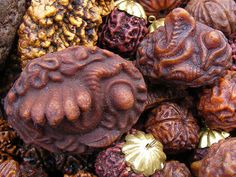 a pile of different types of nuts and other things on display in a bowl together