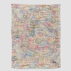 a square scarf with stamps all over it and the words written in different languages on it