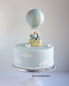 a blue and white cake with a hot air balloon on top