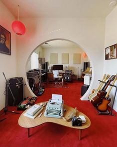 a living room filled with furniture and musical instruments