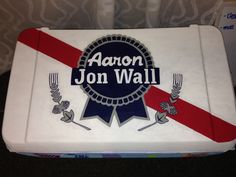 a lunch box with the name aaron jon wall on it