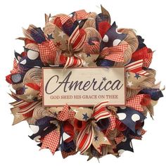 an american wreath with the words god shed his grace on thee written in red, white and blue