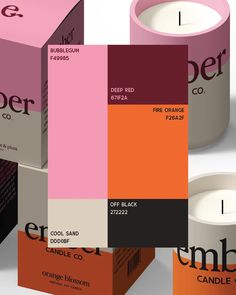 an image of candles that are designed to look like color swatches on paper and cardboard boxes