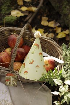 a basket filled with apples sitting on top of a table