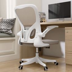 a white office chair sitting in front of a desk with a computer monitor on it