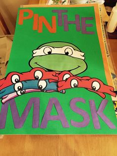 there is a poster on the table that says pin the mask