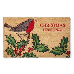 a christmas door mat with a bird on it and holly leaves around the edges that says, christmas greetings