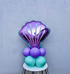 a chair that has some balloons on top of it and an under the sea decoration