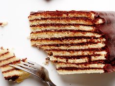 a piece of cake on a plate with a fork next to it and another slice missing