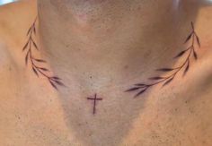 a man with a cross tattoo on his chest