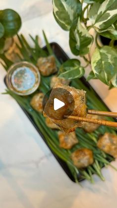 the food is being prepared and ready to be eaten on the table with chopsticks