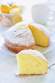 a lemon cake on a plate with a slice cut out