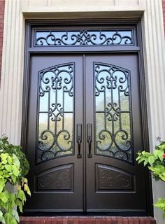 a black double door with decorative iron work