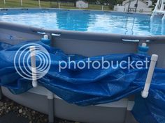 an above ground swimming pool with blue tarp around it and the words photobuckett