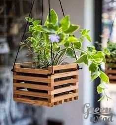 a wooden hanging planter filled with plants