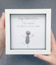 a person holding a rock in their hand with the words happy retirement written on it