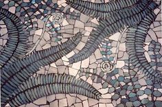 an artistic mosaic design with blue and white tiles on it's surface, including leaves