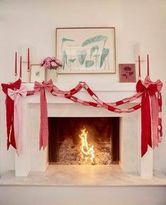 a fireplace decorated with red and white ribbon