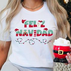 This Feliz Navidad shirt is perfect for spanish Christmas. This classic Bella Canvas unisex jersey short sleeve tee fits like a well-loved favorite. Soft cotton and quality print make users fall in love with it over and over again. These t-shirts have-ribbed knit collars to bolster shaping. The shoulders have taping for better fit over time. Dual side seams hold the garment's shape for longer.  .: 100% Airlume combed and ringspun cotton (fiber content may vary for different colors) .: Light fabric (4.2 oz/yd² (142 g/m .: Retail fit .: Tear away label .: Runs true to size Items shown in mock photo are not included- just the shirt.    To view other unique designs, visit my full shop at: https://etsy.me/3Qg9Xbn. DIRECT TO GARMENT (DTG) PRINTING: Direct to Garment printing is when a high resol Feliz Navidad Shirt, Spanish Christmas, Matching Family Christmas Pajamas, Family Christmas Pajamas, Merry Christmas Shirts, Pajama Shirt, Christmas Pajamas, Family Christmas, Christmas Shirts