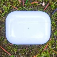 an apple airpods sitting in the grass