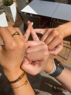 two people holding their hands together with the fingers in the shape of an x and v