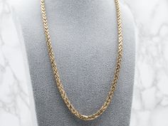 This chain is in excellent condition, and it's a piece that is going to be useful and worn frequently for years to come. The style of the chain is loose enough to allow for movement when worn, preventing the chain from being tangled and feeling very nice on the skin. The link style is known as a wheat chain, due to its straight, yet ever so slightly curved links that when woven together look like the tops of wheat! Metal: 10K Yellow GoldWidth of Chain: 5.3 mmLength of Chain: 22 InchesMarks: “MID Tangled, Wheat, Chain Necklace, Gold Necklace, Yellow Gold, Chain, Skin, Yellow, Gold