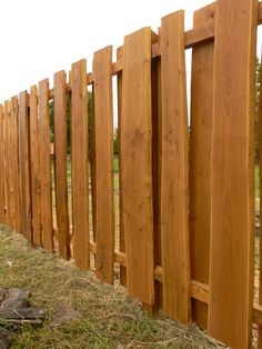 a wooden fence that has been made to look like it is going over the grass