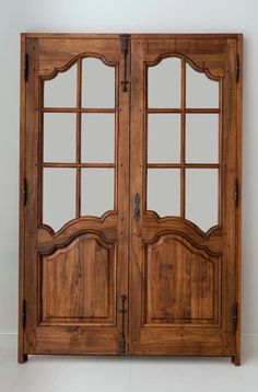 an old wooden double door with glass panels