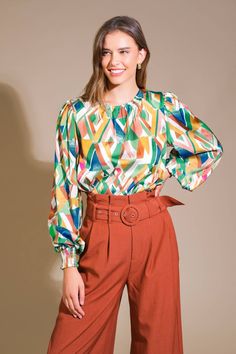 A printed woven top featuring round neckline, blouson sleeve with smocked cuff and back neck button closure Details: Self : 100% Polyester Size & Fit - Model is 5`8" And Wearing Size Small- Measurements Taken From Size Small- Approx. Length: 23" Multicolor Lantern Sleeve Printed Blouse, Multicolor Printed Lantern Sleeve Blouse, Multicolor Printed Blouse With Lantern Sleeves, Fall Printed Tops With Balloon Sleeves, Fall Tops With Printed Balloon Sleeves, Fall Tops With Balloon Sleeves And Printed Details, Multicolor Blouse With Smocked Cuffs For Fall, Multicolor Fall Blouse With Smocked Cuffs, Chic Printed Blouse With Balloon Sleeves