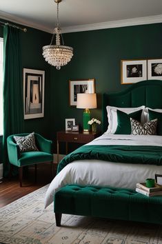 a bedroom with green walls, white bedding and a chandelier hanging from the ceiling