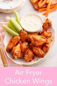 air fryer chicken wings on a plate with celery, carrots and ranch dressing