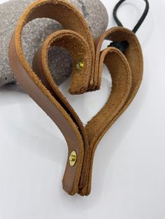 two pieces of leather are shaped into the shape of a heart