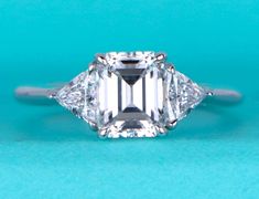 an emerald cut diamond ring with three side stones